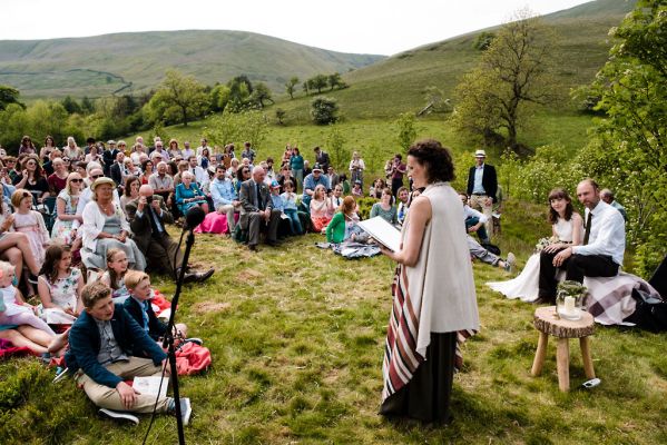 Guests assembled in Edale as Celebrant Keli Tomlin officiates over an outdoor wedding ceremony