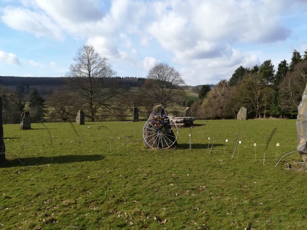 The entrance to the Stone Circle at Ruthin Castle decorated for a medieval wedding ceremony with feathers, roses and a white wheel