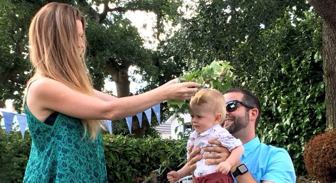 A small child has an icy crown placed on its head by its mother during a Naming Day Ceremony by Keli Tomlin Ceremonies